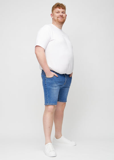 Fuldt billede af en plus-size model i denim regular middle shorts.